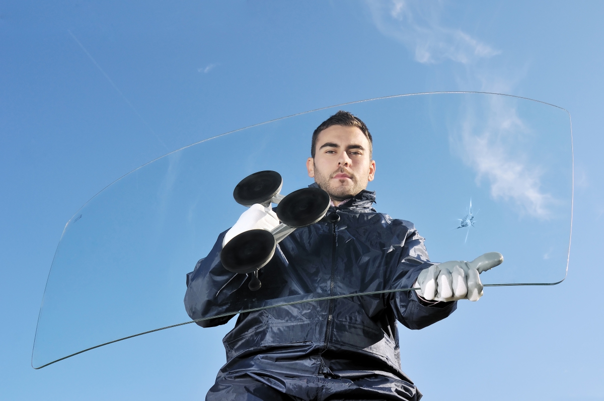 Worker Carrying a Chipped Windshield