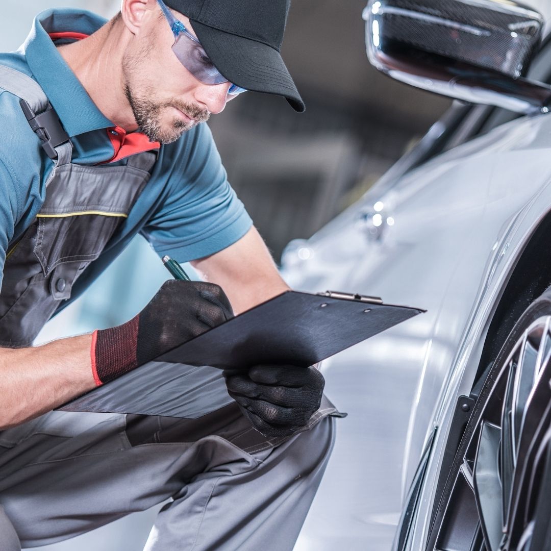 mechanic writing on clipboard