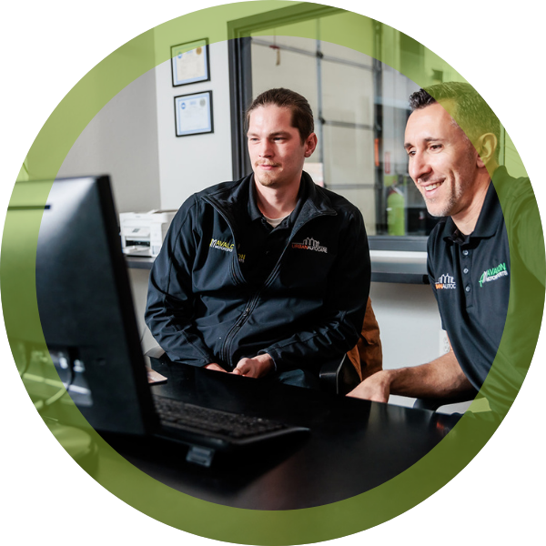 Two techs looking at computer screen