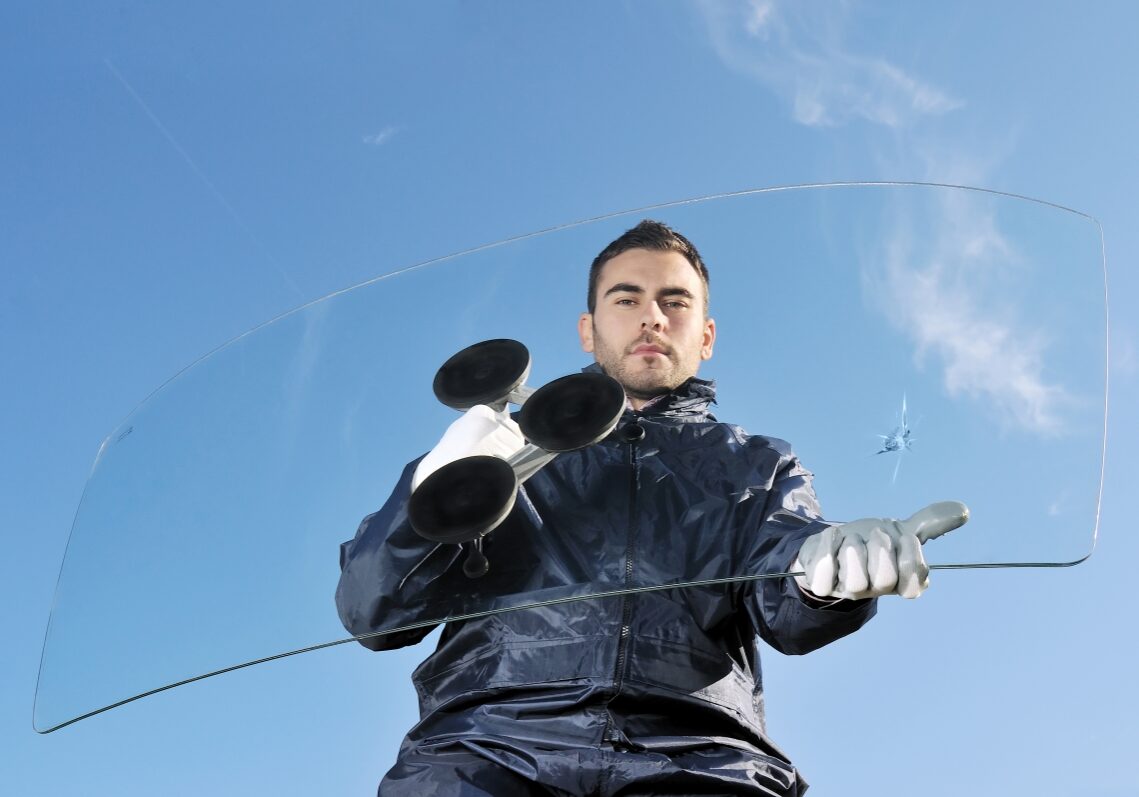 Worker Carrying a Chipped Windshield