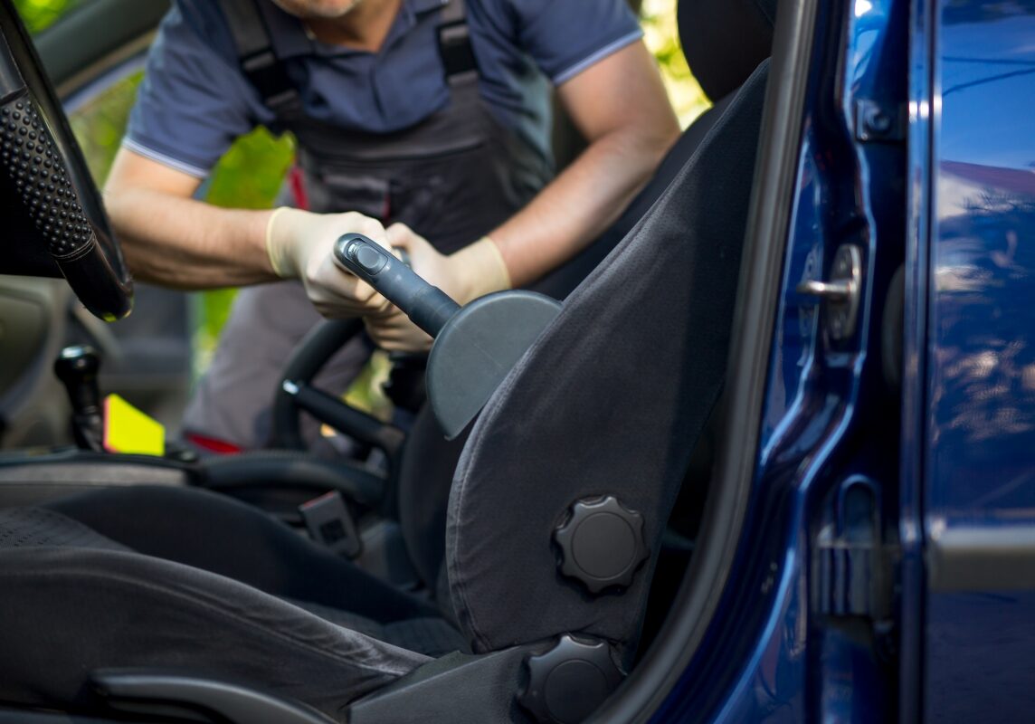 Worker Detailing a Car